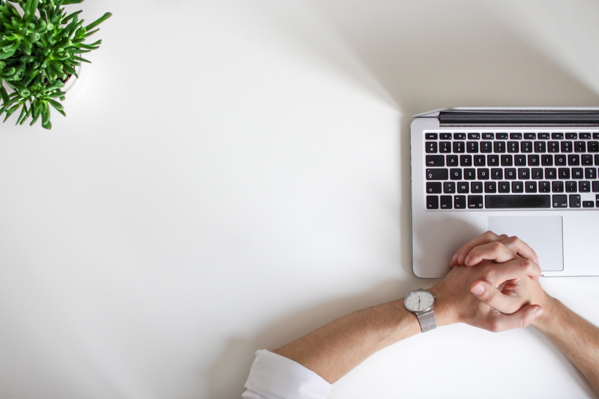 person wearing watch near laptop